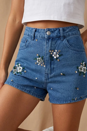 İşlemeli mini kot şort, kadın, mavi denim, çiçek ve boncuk detaylı, yüksek bel, ön görünüm.
